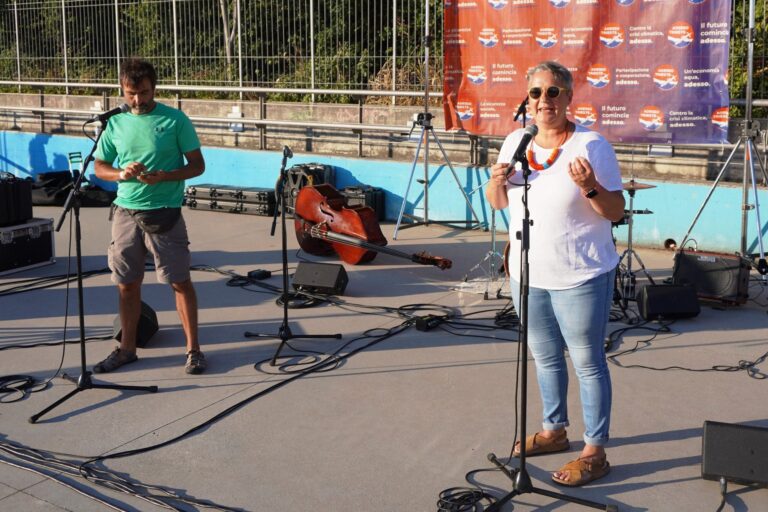 Soundcheck live all’aperto con cantante e chitarrista, microfoni e cavi audio.